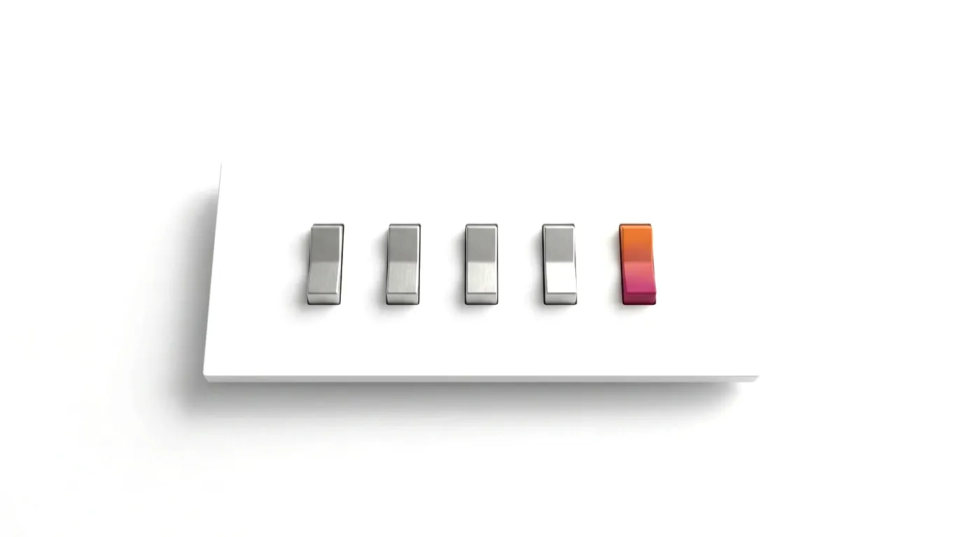 Five switches in a row on a white panel - the one in colour is the one left to switch